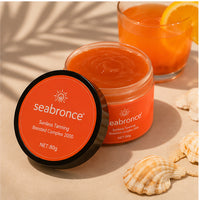 Bote de Seabronce abierto junto a un refresco de naranja